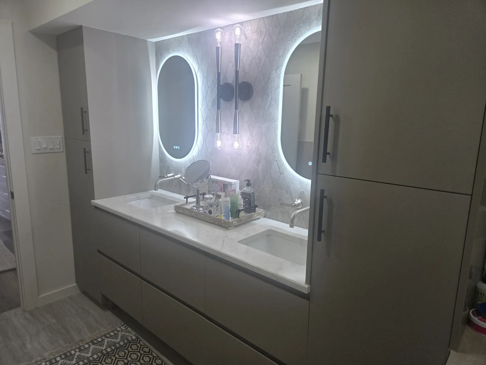 Double vanity with backlit mirrors in the same home