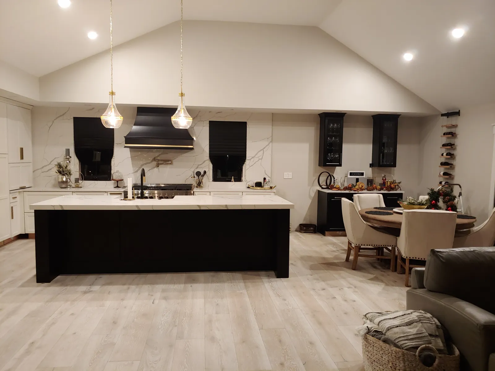 White shaker kitchen with a black hood and dark stained island