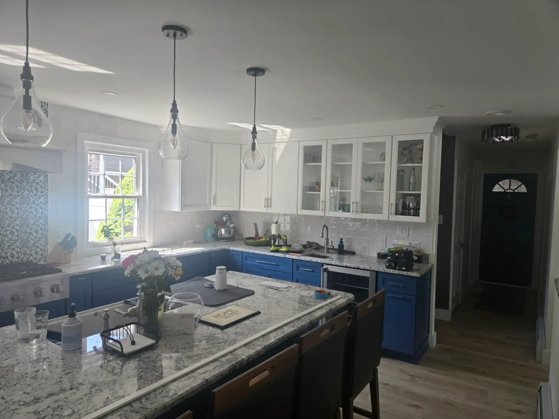 Blue island with glass front upper cabinets