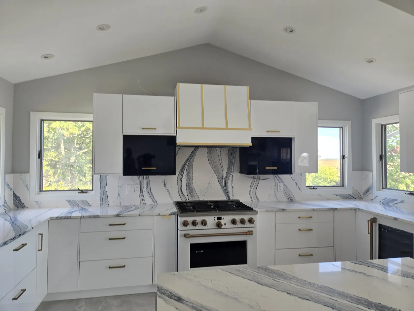 Full height stone backsplash behind the range