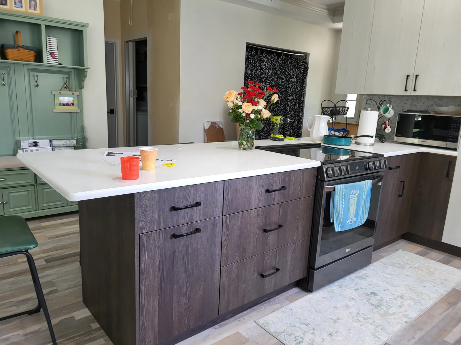 Flat panel wood island with a painted hutch beyond