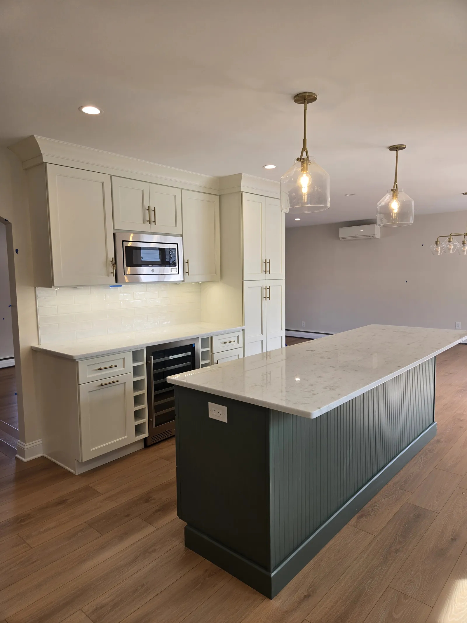 White shaker kitchen with a green island