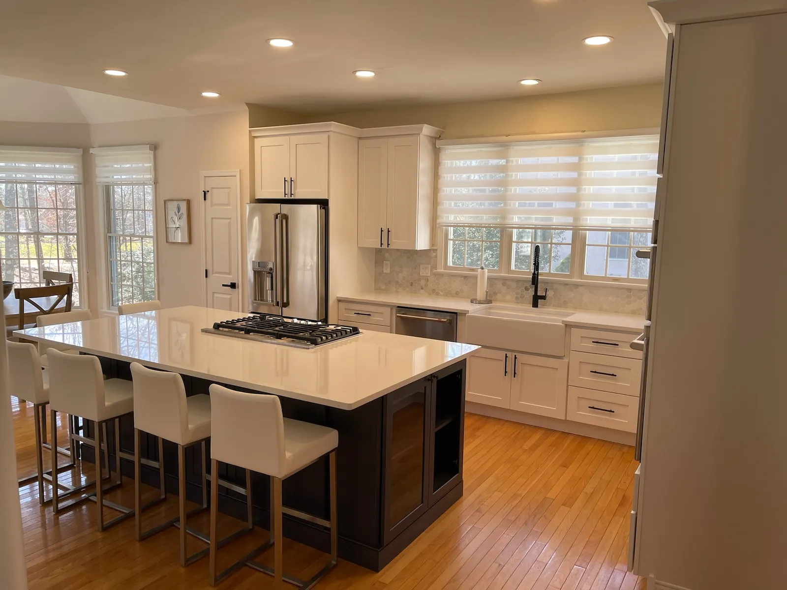 Modern kitchen with glossy white cabinets and a walnut island