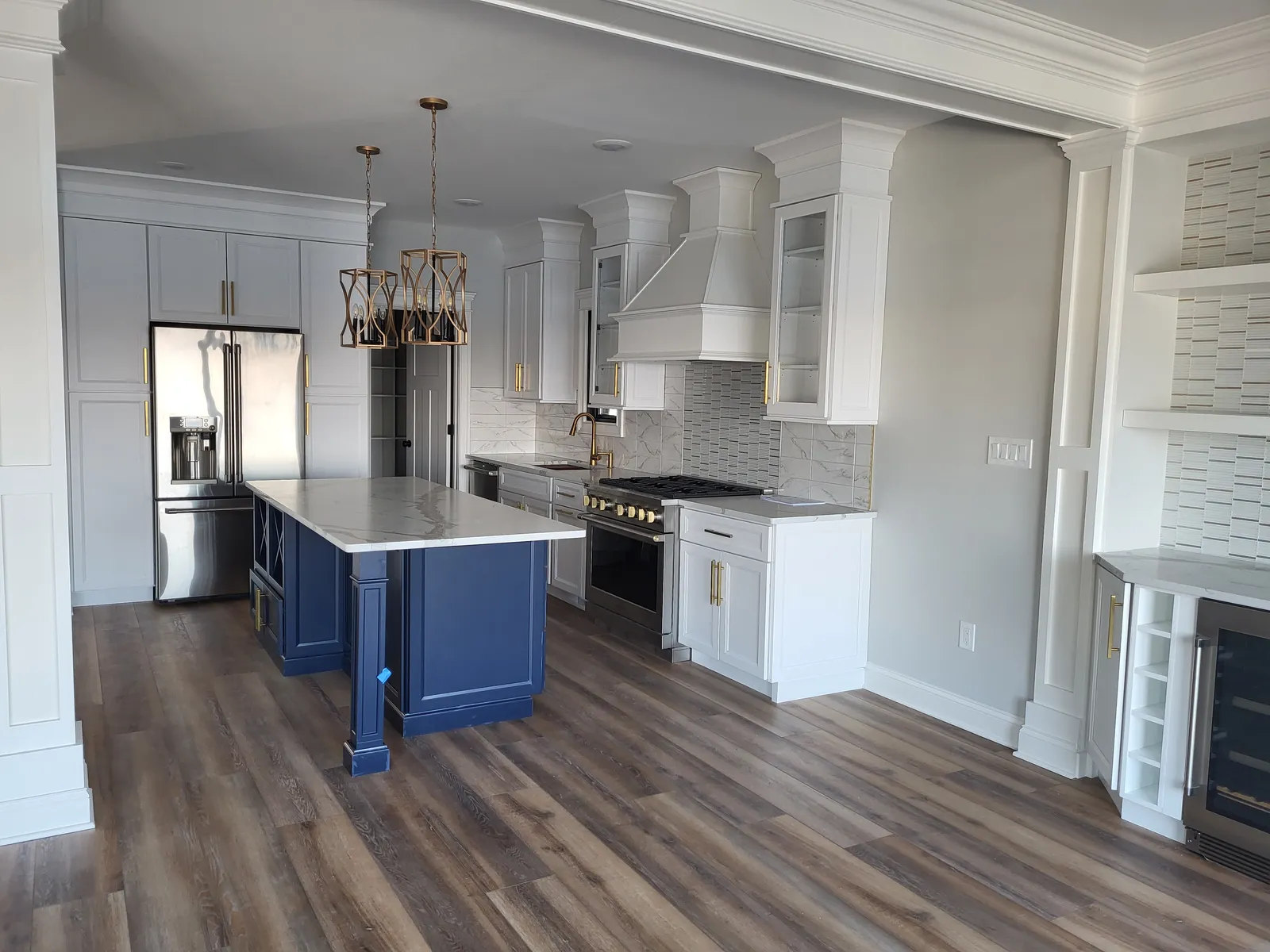 White kitchen with a navy island with X end panels