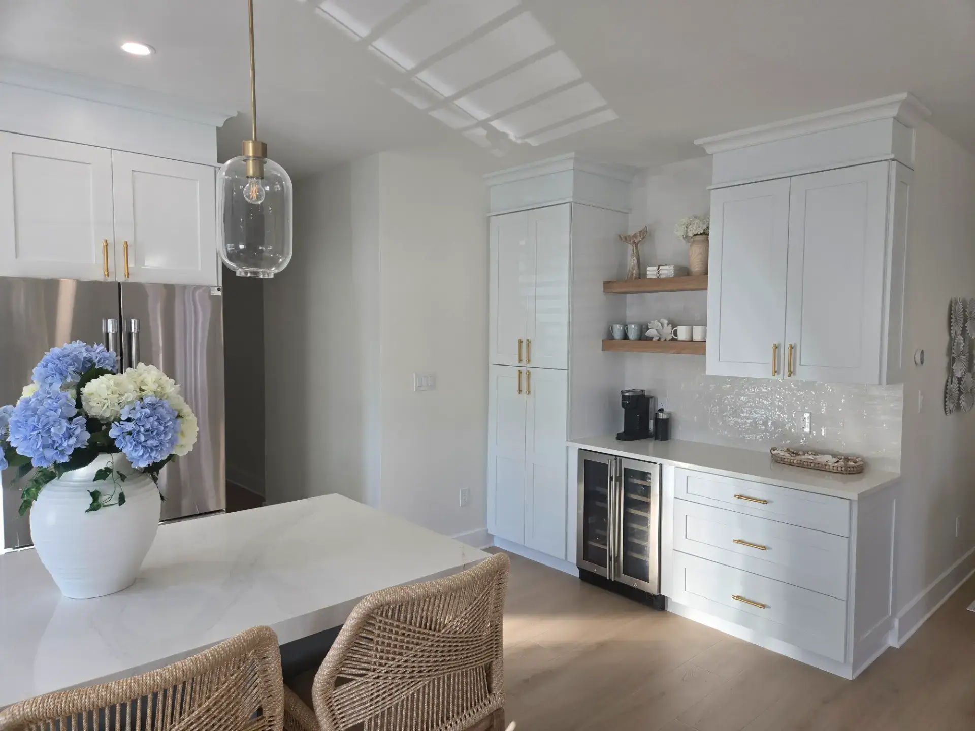 Bright white kitchen with an island and dining seating