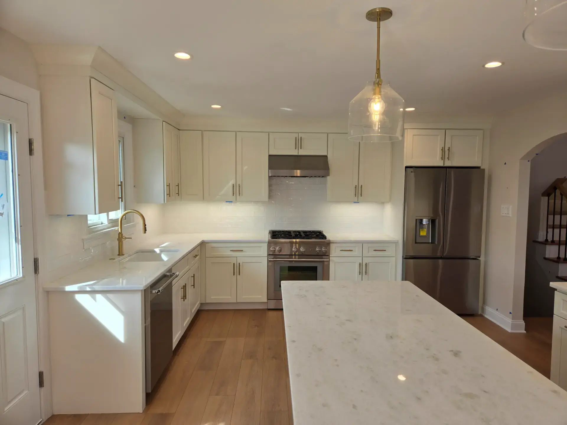 Classic white kitchen with a marble topped island