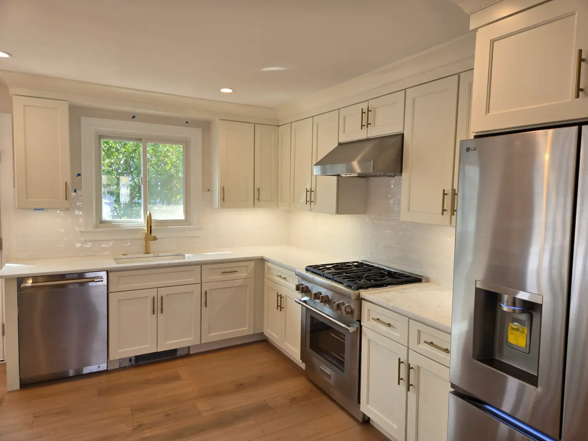 Compact white kitchen in an L shaped layout