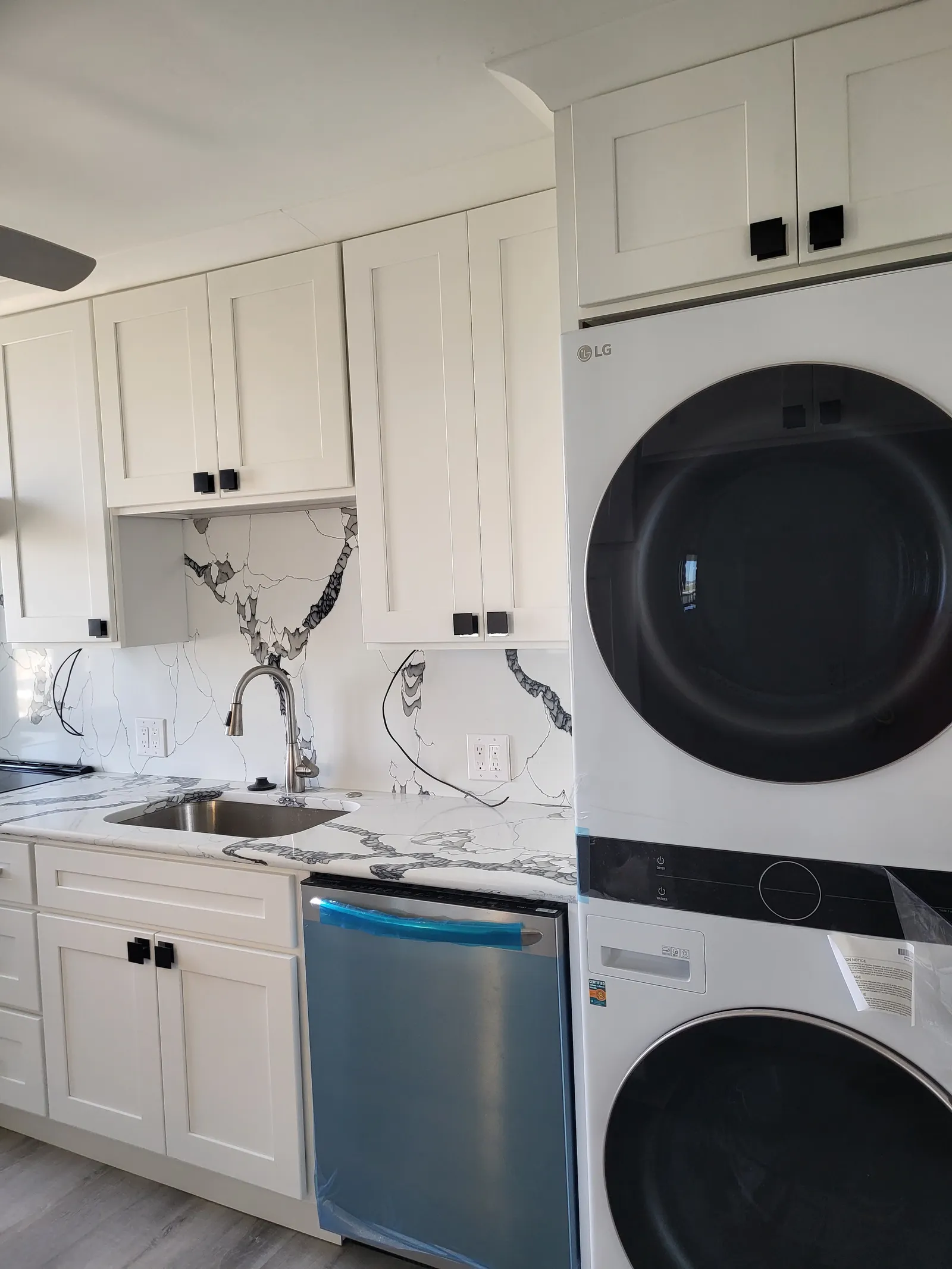 Laundry room with stacked washer and dryer built into cabinetry