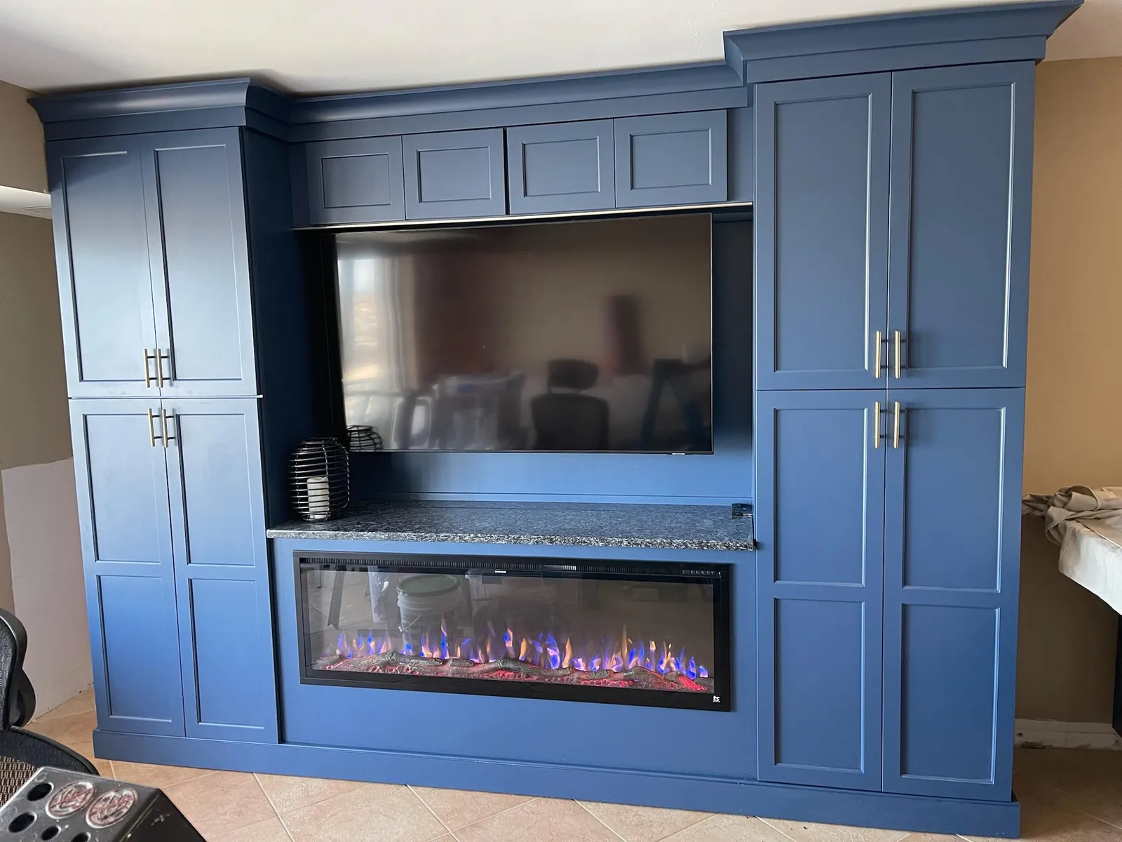 Navy built in media wall with an electric fireplace
