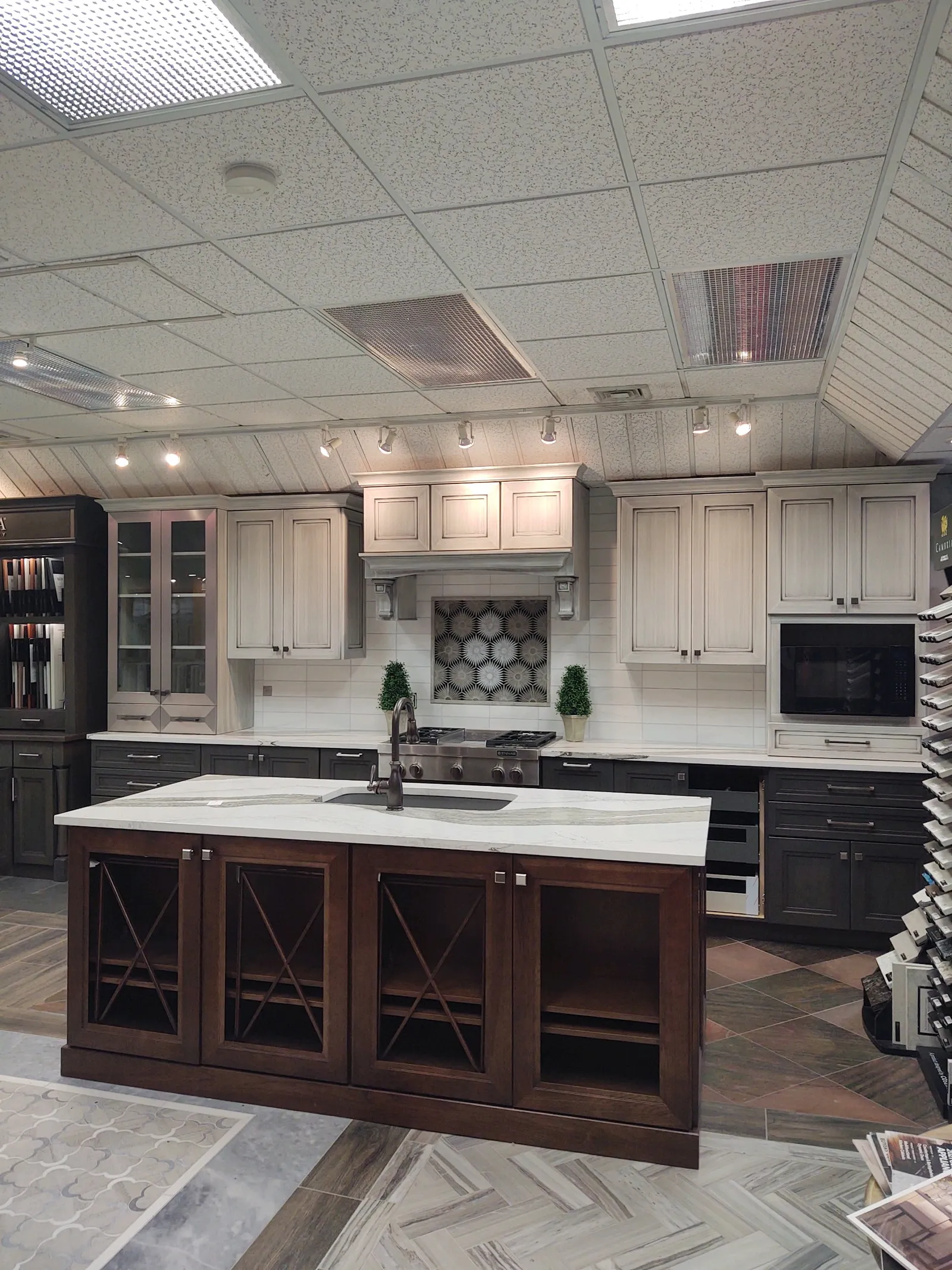 Showroom display with a stained island and glass front hutch